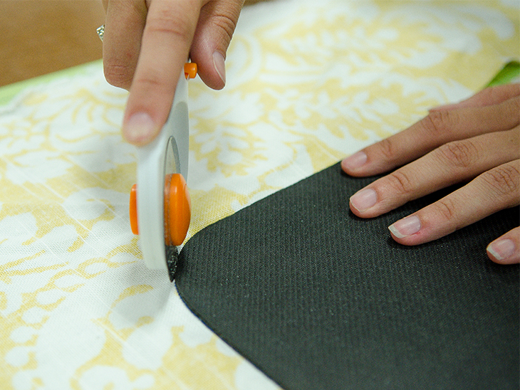 Use a rotary cutter to cut the fabric out around the mouse pad